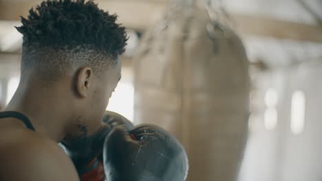 slow motion boxer punching boxing bag