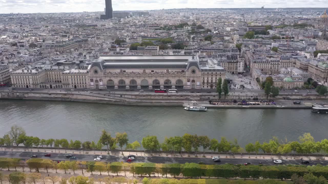 Stunning aerial drone video flies closely above the Musée d'Orsay with sweeping views of the Tuileries Garden and the Seine River in Paris