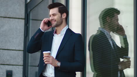 closeup businessman smiling outdoors. businessman drinking take away coffee