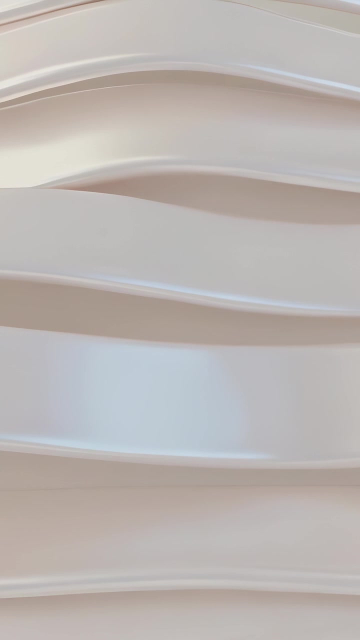 Vertical video: Shifting camera revealing sculpted wavy wall panels in room, showcasing texture