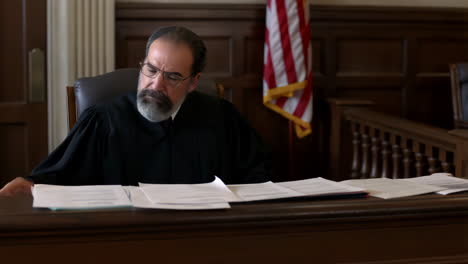 a judge reviewing documents in a courtroom