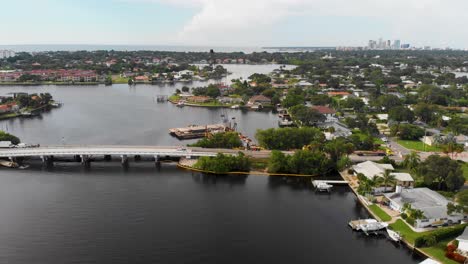 4k drone video of crane repairing bridge on tampa bay in st petersburg, florida on sunny summer day-1