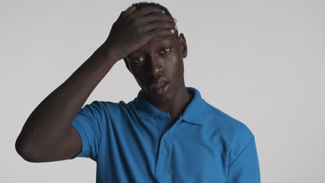 incredulous african american man on grey background.