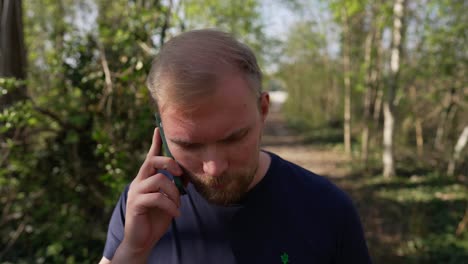 angry phone call, man talks on mobile phone outdoors, caucasian male