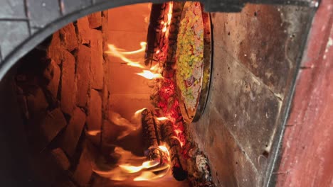 Pizza-cooked-in-the-oven-among-the-fires,-delicious-pizza