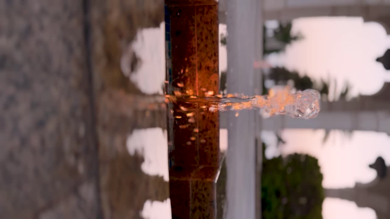Simple stream of water in a garden fountain at sunset at a palace, courtyard, Mosque, or garden - vertical