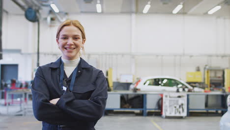 portrait of female student studying for auto mechanic apprenticeship at college