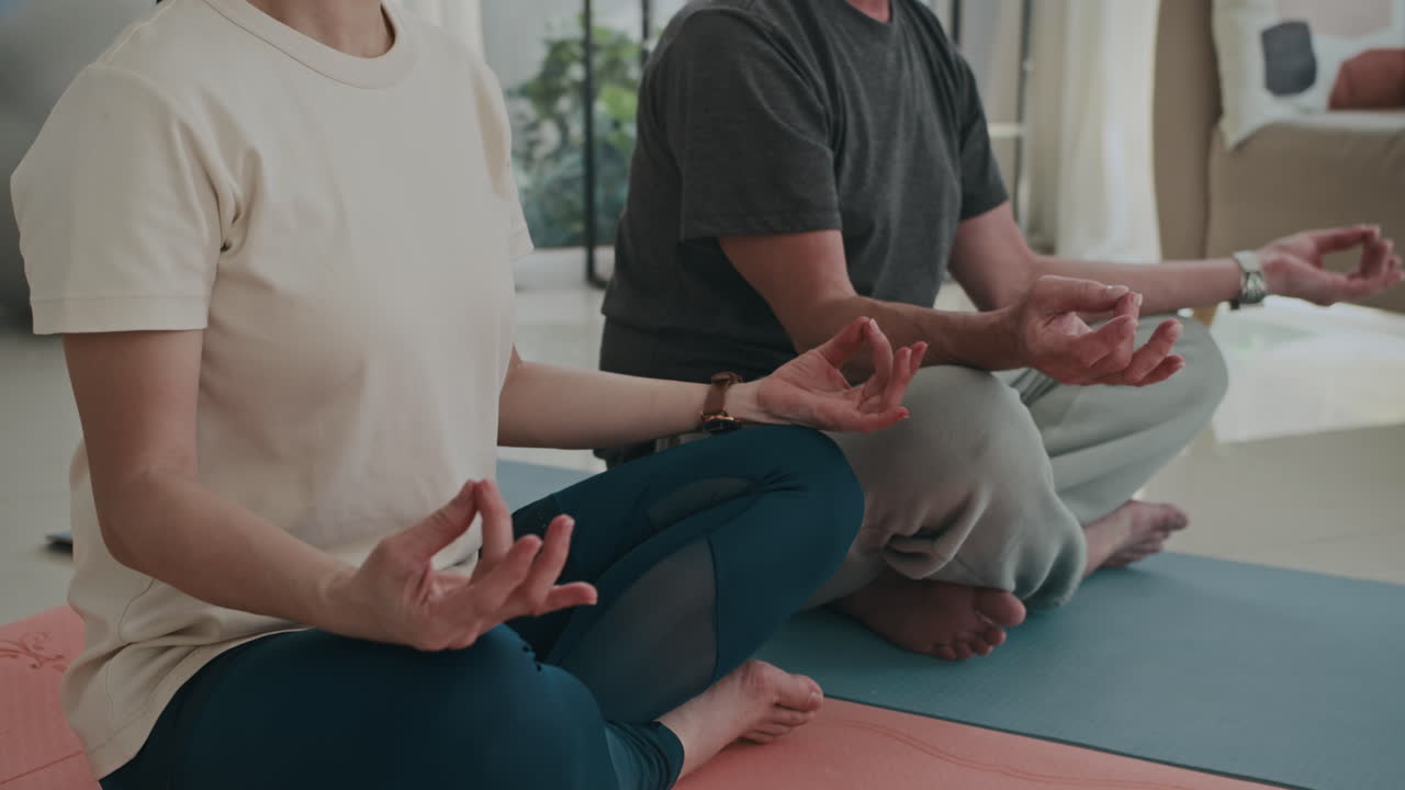 Relaxed Man and Woman Breathing in Lotus Position Indoors