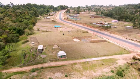 Tilting-drone-flight-of-busy-local-market-in-tribal-village-of-kapenguria,-traditional-rural-community-in-Kenya-Africa