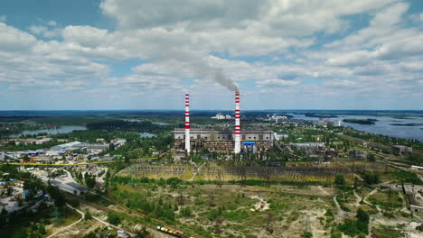 industrial factory exterior with smoke from chimney. aerial landscape