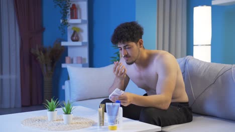 young man applying treatment cream to his face and skin.