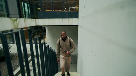 man walking up stairs in urban setting