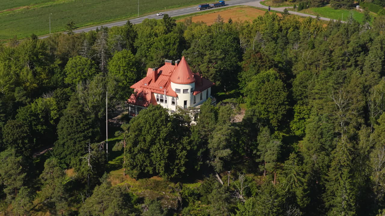 Aerial telezoom orbiting the Majvik's historic Art Nouveau Villa, in Kirkkonumm