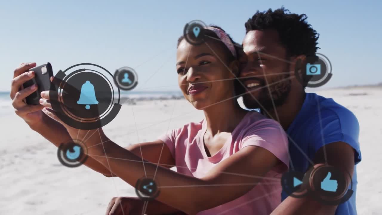 Animation of media icons over african american couple using smartphone