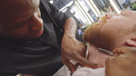 Black-Barber-Using-Straight-Razor-for-Shaving-Client