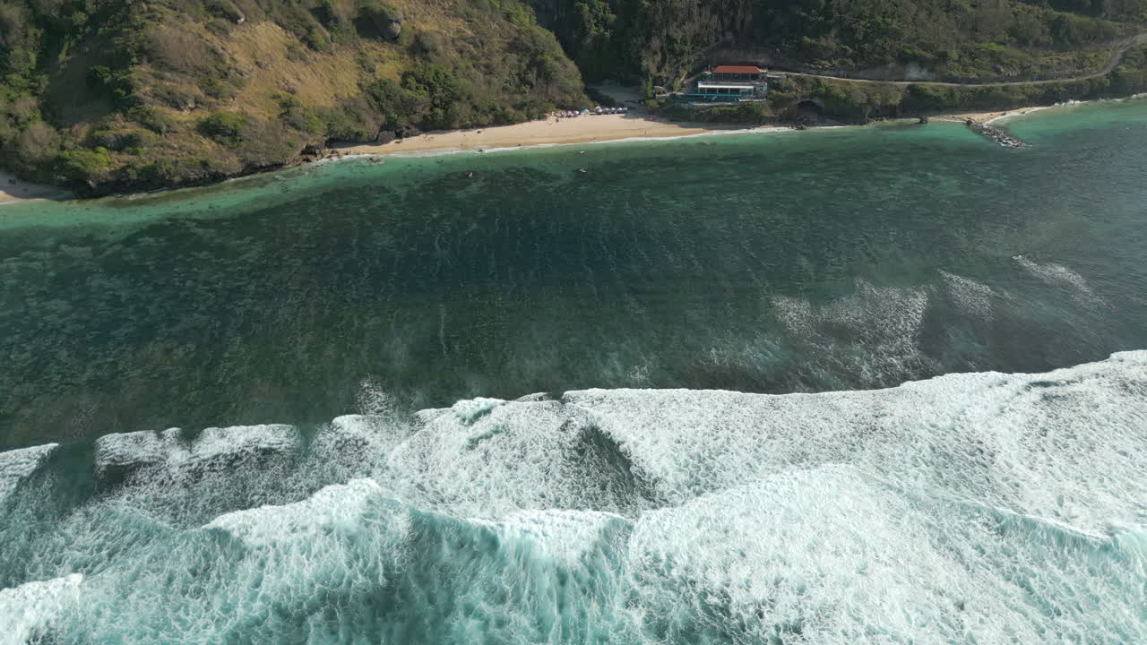 Drone Pan Up Over Rugged Uluwatu Cliffs And Hidden Beach Bali Indonesia 4K 60FPS