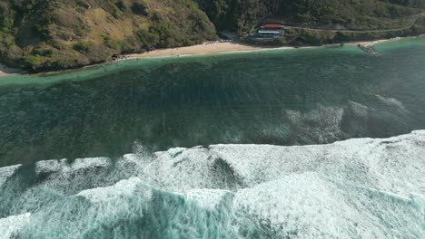 drone pan up over rugged uluwatu cliffs and hidden beach bali indonesia 4k 60fps