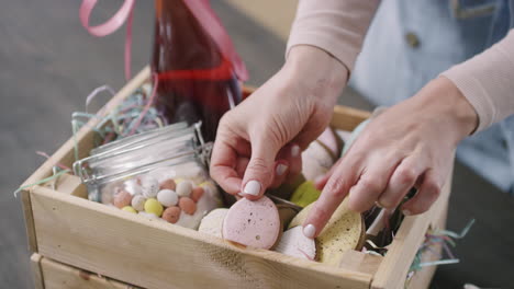 woman arranging easter gift basket