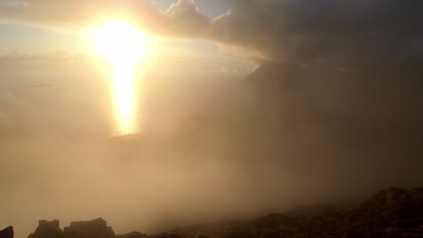 fog rolls over mountains above utakleiv during midnight sun timelapse from mannen in lofoten