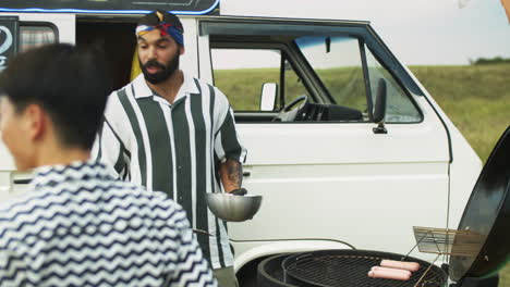 Food-Truck-Seller-Cooking-Hot-Dogs-for-Customers