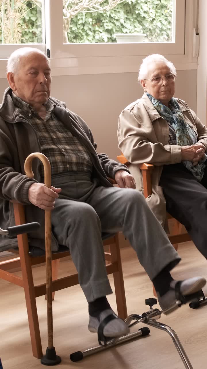 Senior people exercising with bike pedals in retirement home
