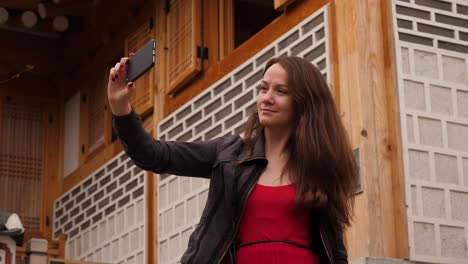 attractive woman take selfie photo at korean traditional village