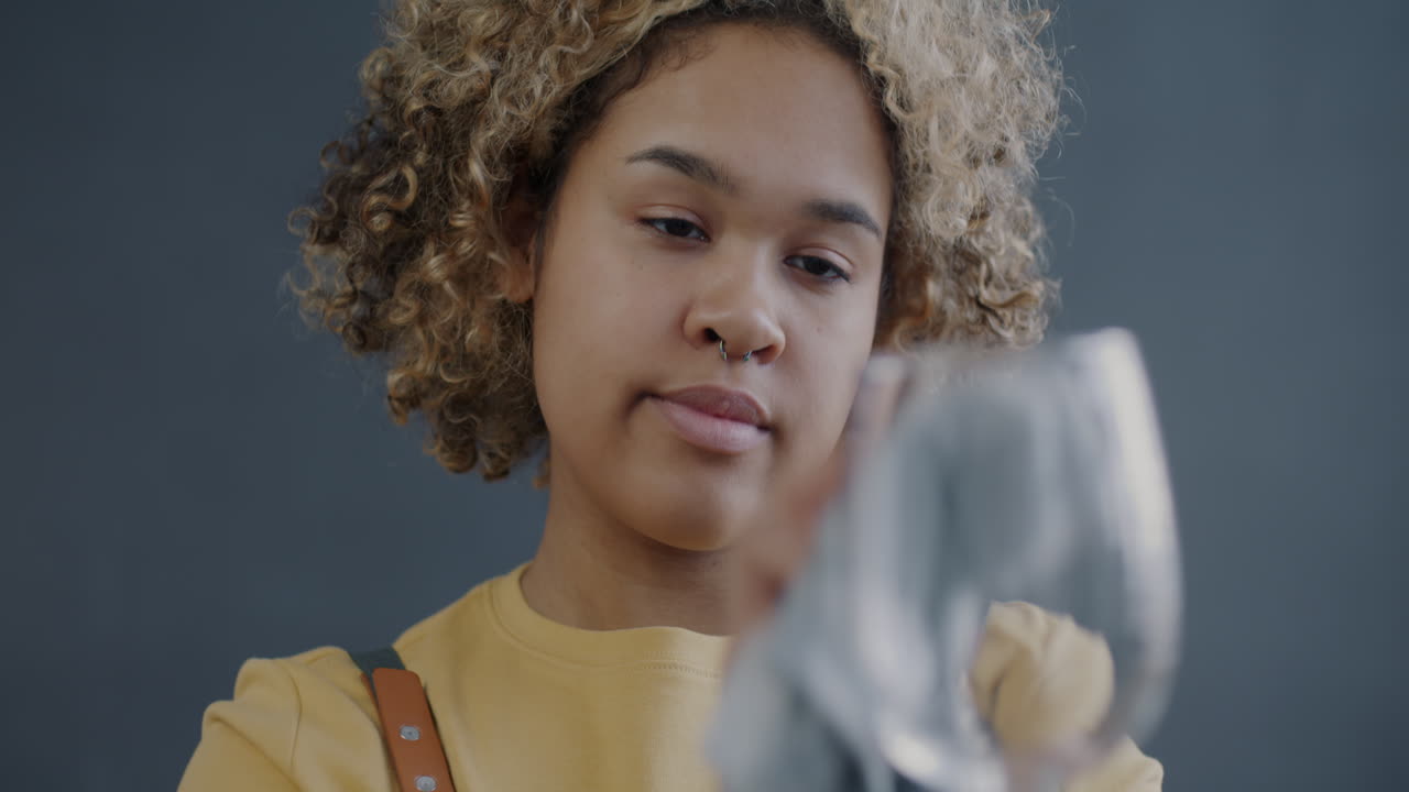 Woman Cleaning a Wine Glass