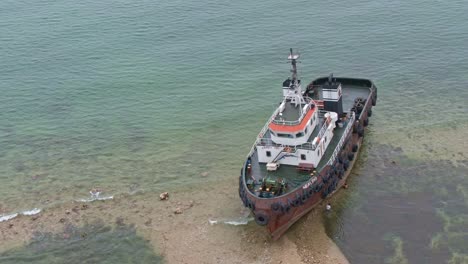 drone side view shot of shipwreck on the seashore