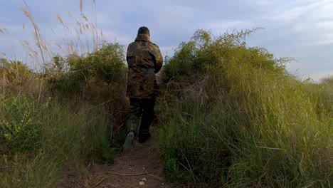 A-volunteer-soldier-or-freedom-fighter-takes-cover-in-a-fortified-bunker-as-the-enemy-approaches-at-sunset