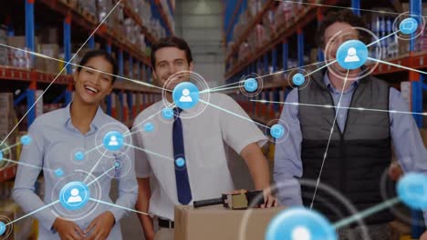 Animation-of-network-of-connections-with-icons-over-diverse-workers-in-warehouse