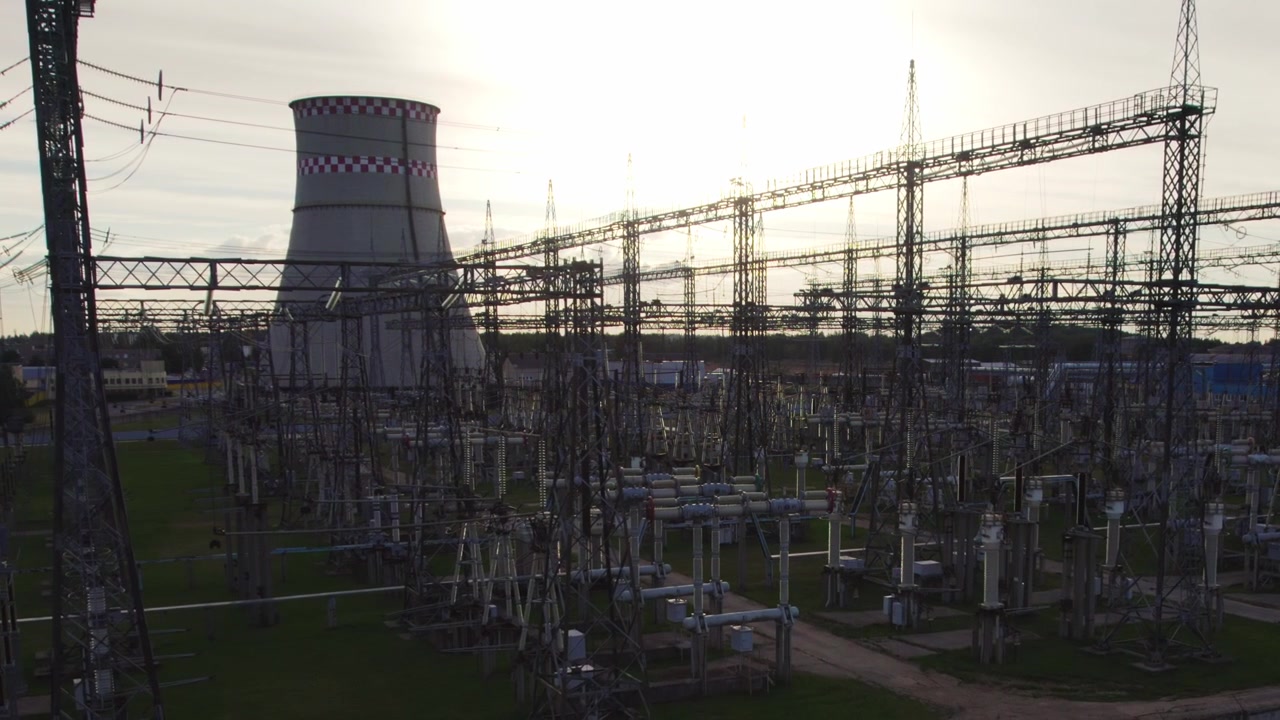 Aerial View of Electrical Substation and Cooling Tower at Sunset