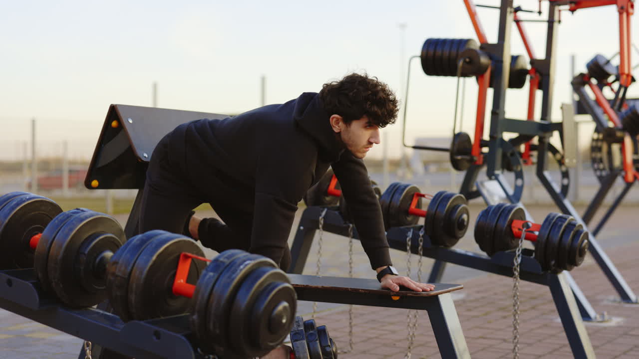 덤벨 을 들고 야외 에서 일 하는 사람