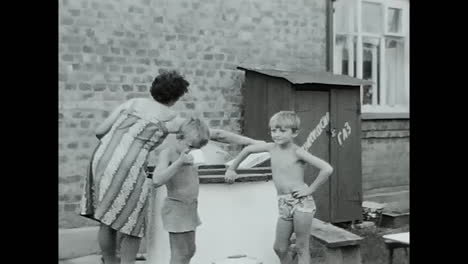 group of children gathered around draw-well in soviet union archive. circa ussr 1970: a group of children in the soviet union standing around a draw-well in an archive.