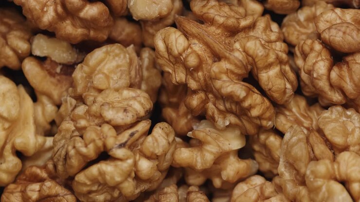 Smooth Camera Movement Over a Handful Walnuts.