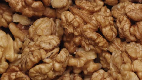 smooth camera movement over a handful walnuts.