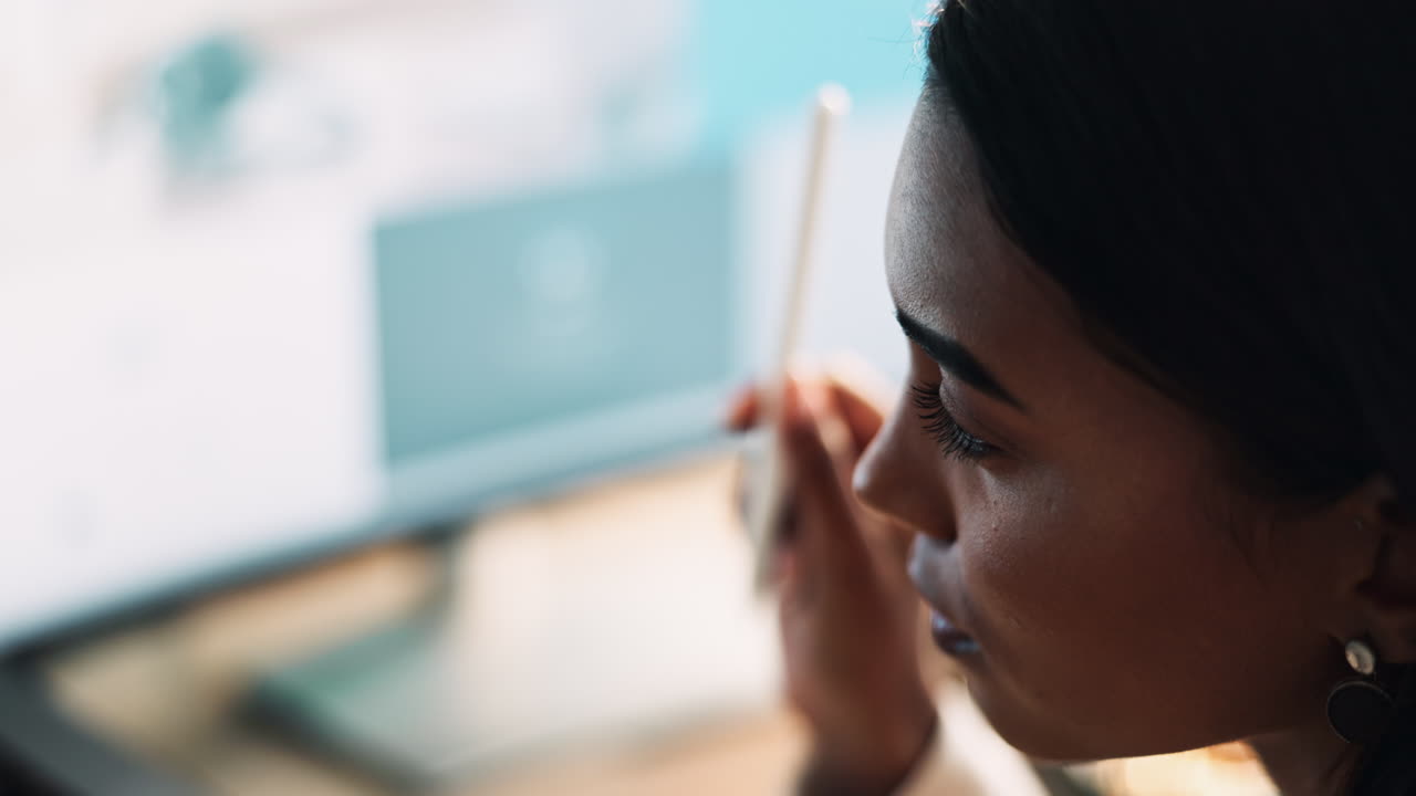 Woman using a digital pen on a computer
