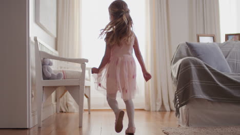 beautiful-little-girl-dancing-playfully-pretending-to-be-ballerina-happy-child-having-fun-playing-dress-up-wearing-ballet-costume-with-fairy-wings-at-home-4k