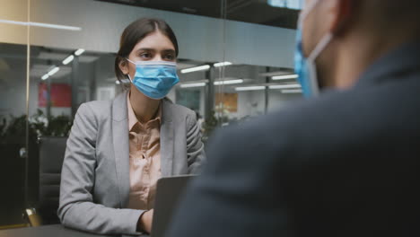 business meeting with face masks in an office setting