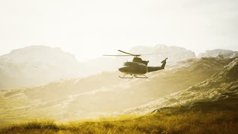 slow motion vietnam war era helicopter in mountains