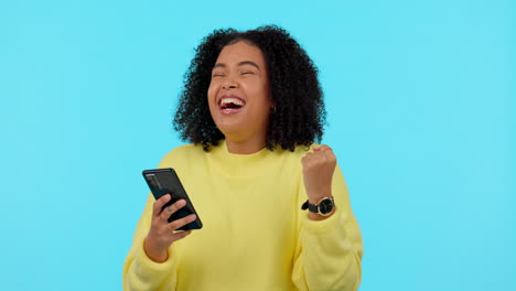 African-woman,-phone-and-celebration-in-studio