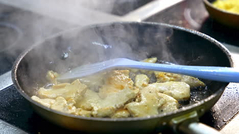 pieces of meat in a frying pan. cooking chicken meat in a hot frying pan. preparation of tasty dish. close-up.
