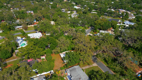 drone overview dolly high above a suburban area of tampa with greenery, homes, and the hillsborough river