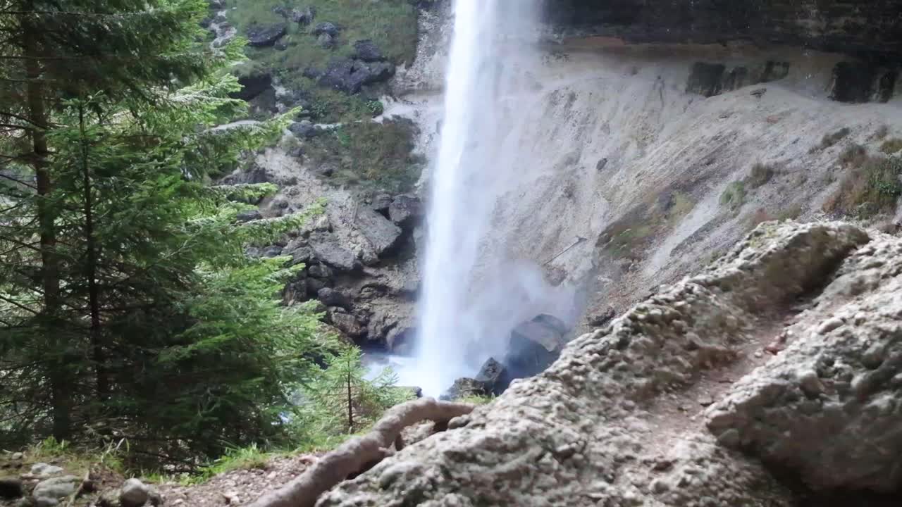 The beautiful waterfall of Pericnik Waterfall in Slovenia. Camera panning from left to right slowly moving the base of the waterfall behind the rocks