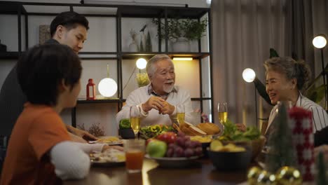 asian family having dinner at dining table at home