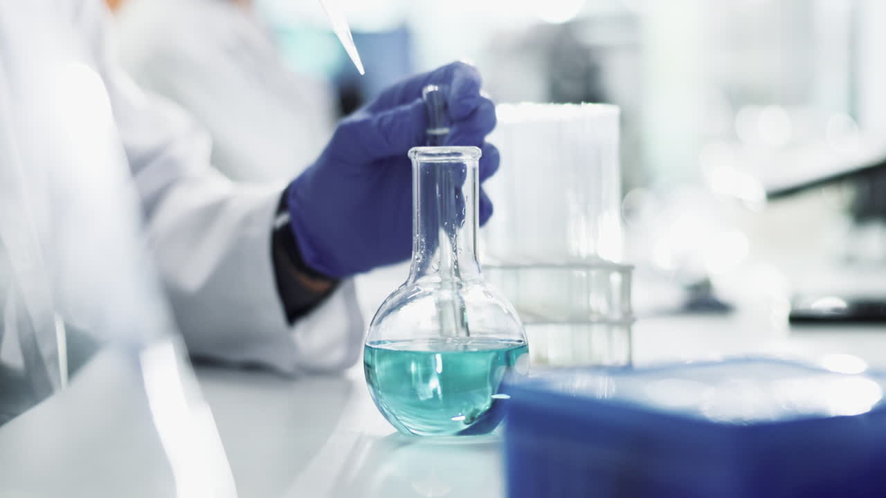 A scientist performing a chemical experiment in a laboratory