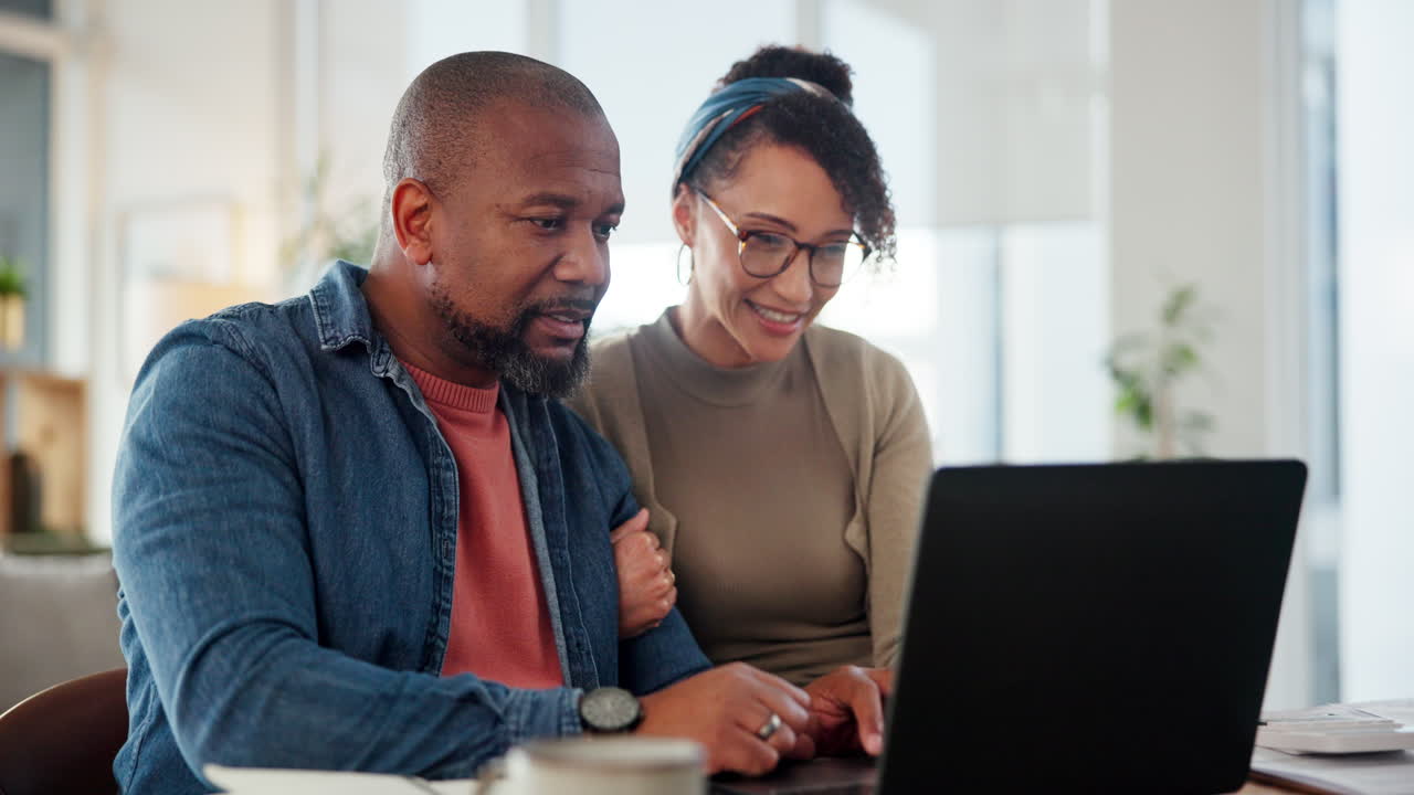 Happy Couple Using Laptop Together