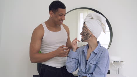 woman with facial mask and handsome black man