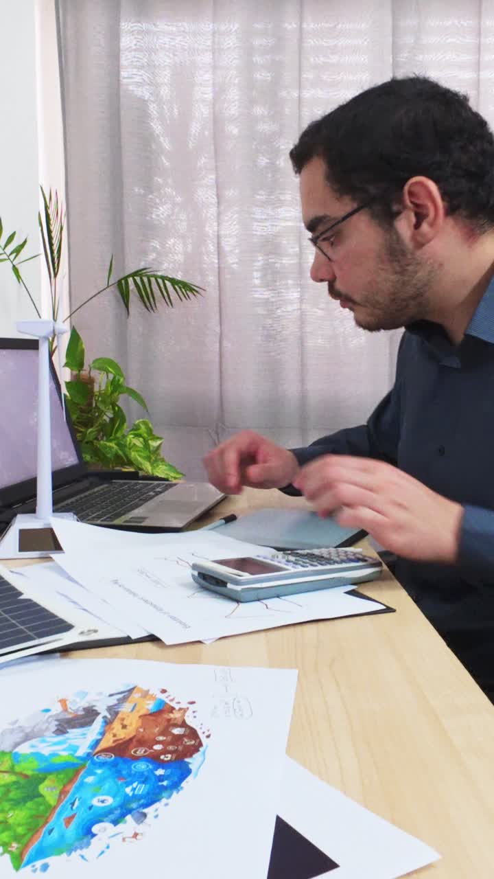 Analyst Typing a Sustainability Report on His Laptop