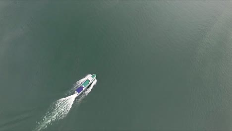 Beautiful-drone-shot-flying-over-water-following-a-cruise-ship-towards-the-scenic-views-of-Norway-on-a-gloom,-cloudy-day