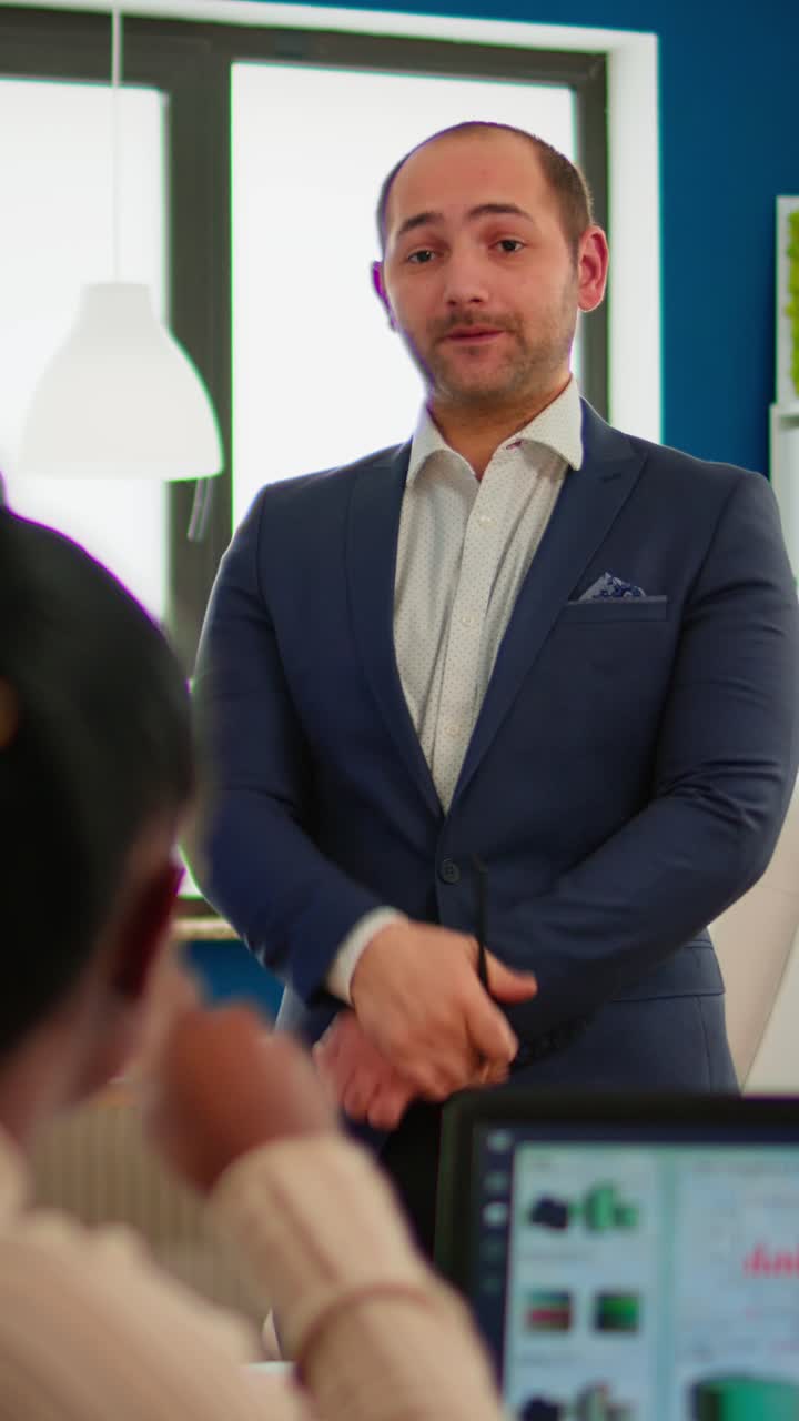 Vertical video Professional man entrepreneur planning new project with his coworkers